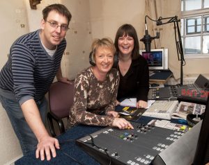 Bishop FM Sue Ellwood (centre) of North Pennine Dales LEADER, tries her hand at broadcasting with help from presenter Rosie Smiles and producer Gary Waldron of Bishop FM.
