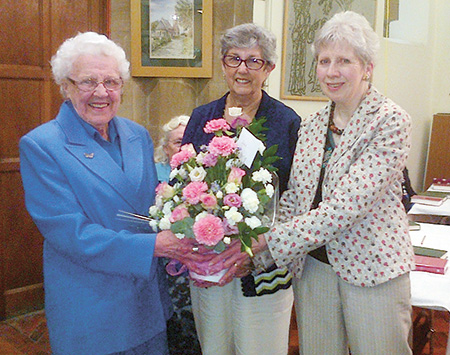 Miss Couper receives a bouquet of flowers on her 90th birthday from Pat Todd and Barbara Hall Gwen_Couper_Pat_Todd_and_Barbara_Hall