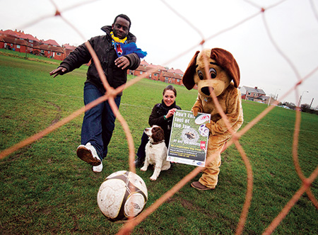 Olivier Bernard, owner of Durham City Football Club, with Durham County Council’s anti dog fouling mascot, Scoop the Dog and Neighbourhood Warden Lyndsey Cartwright. dog-fouling---red-card2a