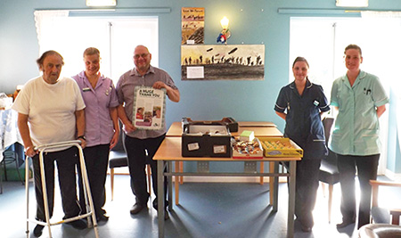 Worshipful Master Phil Barber donates a cake to the staff and residents at Holly Lodge. Masons2
