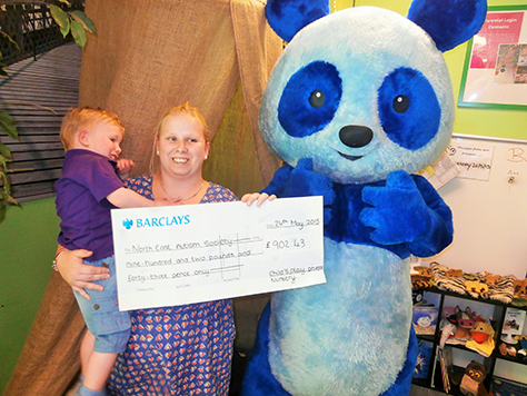 Young Kyle Bransom with his mum and the North East Autism Society’s Big Blue Bear Mascot.