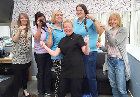 Hairdresser, Julie Dowson Cummings with Ladder Centre staff following their charity haircut in April.