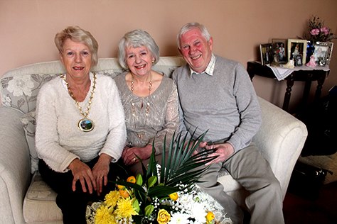 Ferryhill Mayor, Cllr Pauline Crathorne presents a bouquet of flowers and glass tumbler to Betty and Terry Rounsley to celebrate their forthcoming golden anniversary.