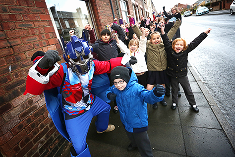 Competition winner, Kieran Potts, his fellow pupils at Dean Bank, and Optimus Prime or (when he’s powered down) Dave Elliot-Cooper from the Histrionics drama company.