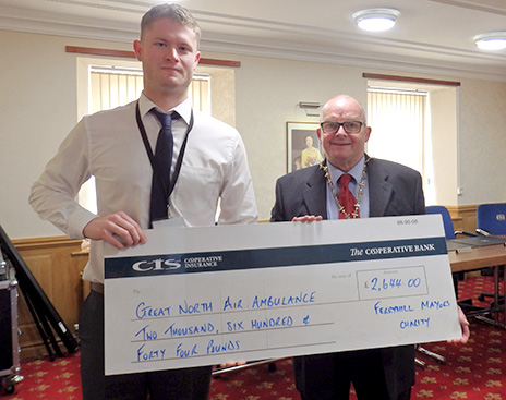 Mayor of Ferryhill, Cllr Peter Atkinson, right, presents a cheque for £2,644 to Ben McWilliams of the Great North Air Ambulance service.