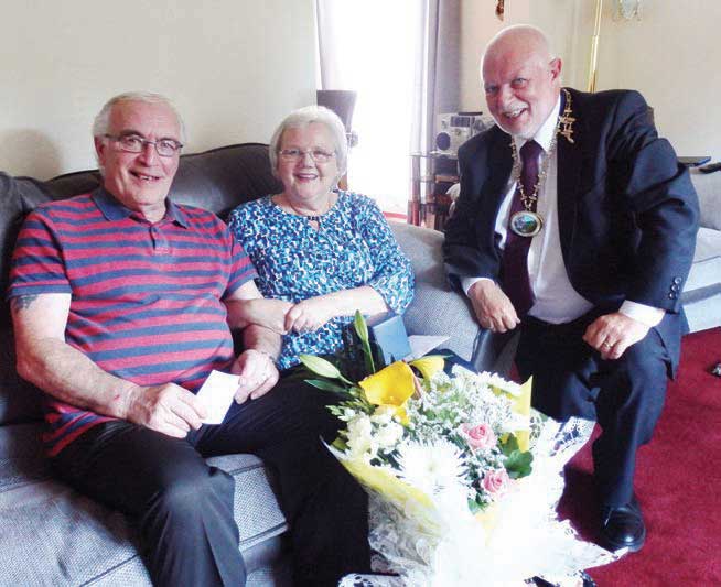 Brian and Valerie McGill receive a bouquet of flowers and a whisky tumbler from Mayor of Ferryhill, Cllr John Lindsay on the occasion of their Golden Wedding anniversary Brian and Valerie McGill receive a bouquet of flowers and a whisky tumbler from Mayor of Ferryhill, Cllr John Lindsay on the occasion of their Golden Wedding anniversary