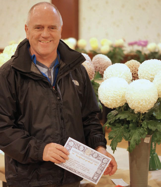 Previous winner Graeme Cooke with his prize winning flowers. Previous winner Graeme Cooke with his prize winning flowers.