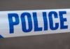 Police officer cuts police tape