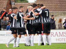 Spennymoor Town's players celebrate after scoring.