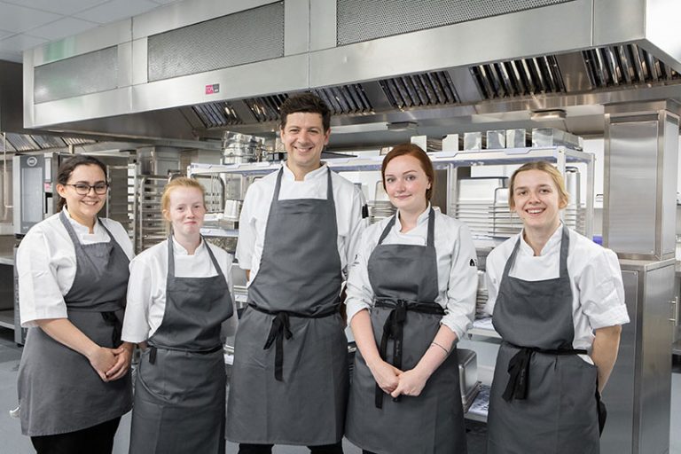 Members of The Auckland Project Catering Team in the Central Kitchen, (L-R) Chef, Katherine Hindes, Commis Chef, Jane Ann Taylor, Culinary Director, Ant Brown, Commis Chef, Lucy Hendron and Commis Chef Emma Rowell.