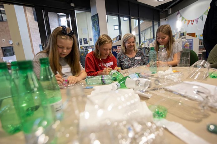 Artist Vicky Holbrough helps children turn plastic bottles into a chandelier at a workshop at Seaham Library.