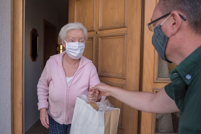 Neighbours delivering packages during coronavirus lockdown. Neighbours delivering packages during coronavirus lockdown.