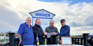 Charity Raceday Brings Back a Smile Charity founder, Kevin Hill (left), with his grandson (right), presenting the winners of the day’s fifth race with their trophy.