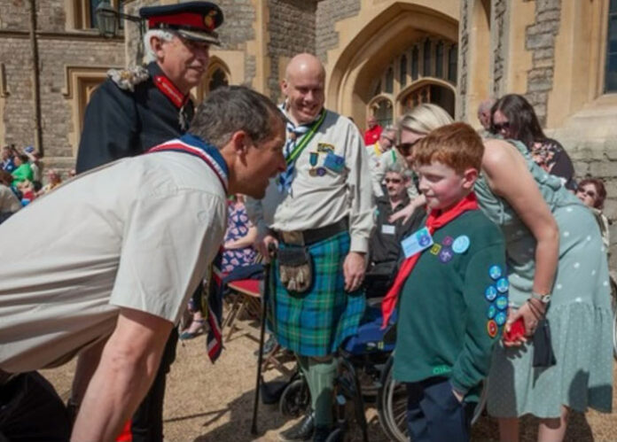 louis-bear-grylls Louis meets Chief Scout, Bear Grylls ahead of the official ceremony at Windsor Castle. Louis and his family have so far raised almost £10,000 for MDUK through the ‘Love for Louis’ fund, which can be donated to at www.musculardystrophyuk.org