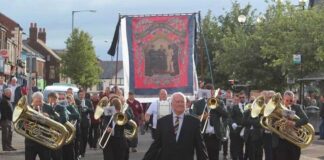 Ferryhill Town Band update Ferryhill Town Band, led by the late Brian Avery, with the banners in the background.