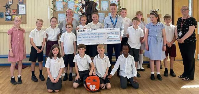 Friends-of-Cleves-Cross-Cheque-Presentation Cleves Cross Primary pupils and staff accept a Members Initiative Fund cheque from Cllr Curtis Bihari.