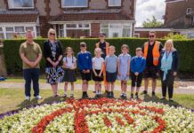 School children help with flower bed projects