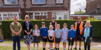 School children help with flower bed projects